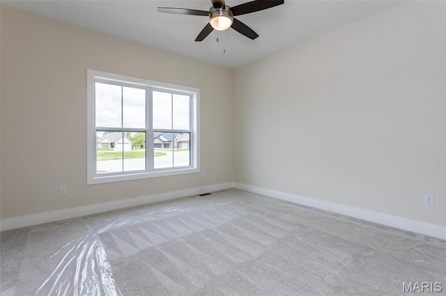 unfurnished room with carpet, ceiling fan, and baseboards