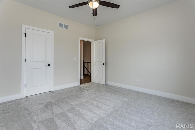 unfurnished bedroom with carpet floors, baseboards, and a ceiling fan