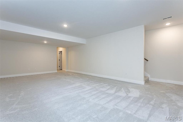finished basement with light carpet, stairs, recessed lighting, and baseboards