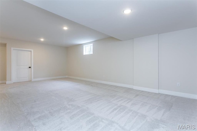below grade area with light colored carpet, baseboards, and recessed lighting
