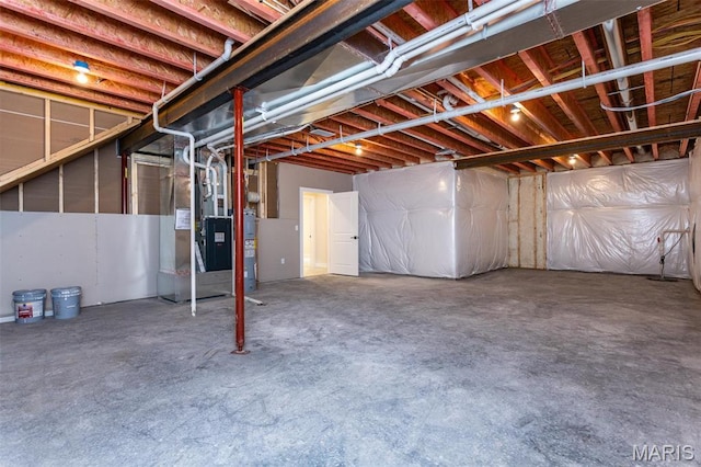 unfinished basement with water heater and heating unit
