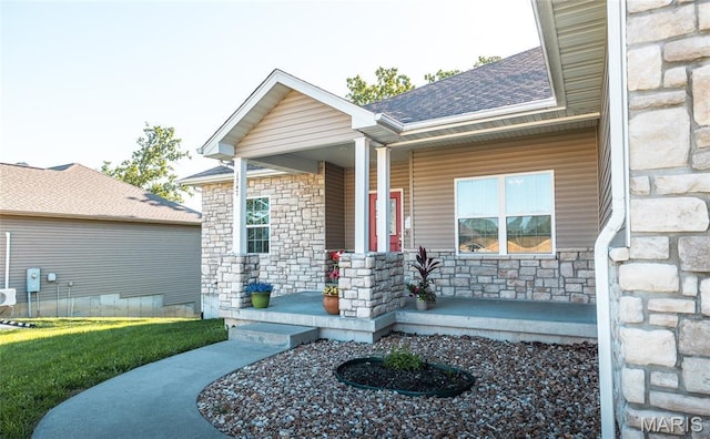 1347 Thomas Dr, Rolla, MO 65401 - property entrance featuring stone siding, covered porch, a shingled roof, and a lawn