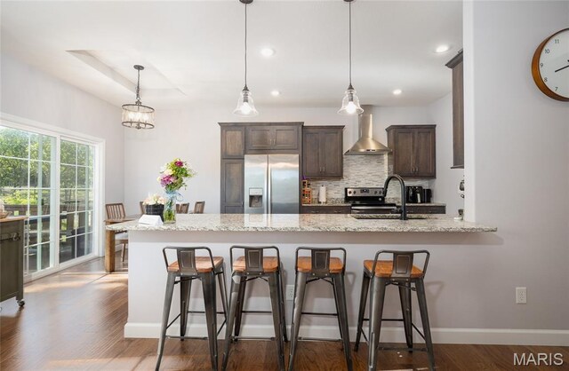 1347 Thomas Dr, Rolla, MO 65401 - kitchen featuring stainless steel appliances, wall chimney exhaust hood, a sink, dark brown cabinets, and backsplash
