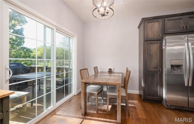 1347 Thomas Dr, Rolla, MO 65401 - dining space with a chandelier, wood finished floors, and baseboards