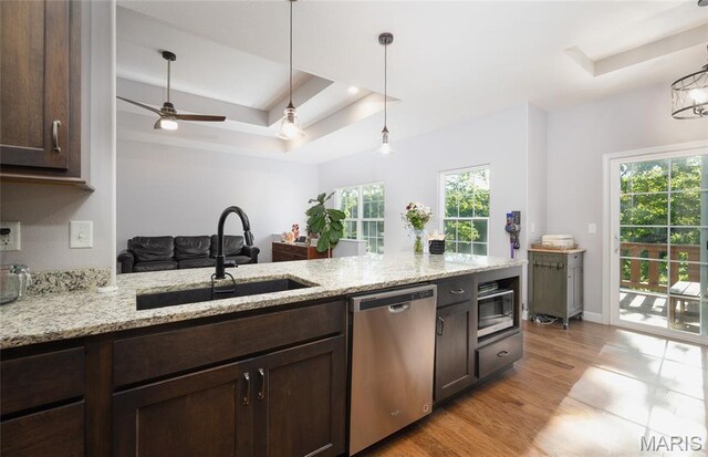 1347 Thomas Dr, Rolla, MO 65401 - kitchen featuring stainless steel appliances, a raised ceiling, a sink, and dark brown cabinetry
