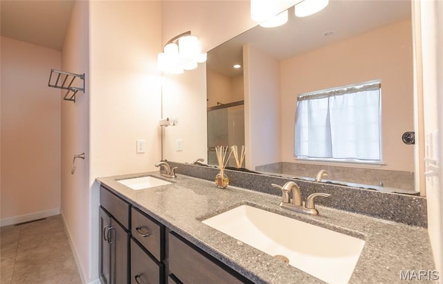 1347 Thomas Dr, Rolla, MO 65401 - bathroom with double vanity, a shower with shower door, tile patterned floors, and baseboards