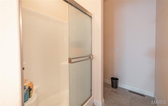 1347 Thomas Dr, Rolla, MO 65401 - bathroom with a shower stall, tile patterned floors, and baseboards