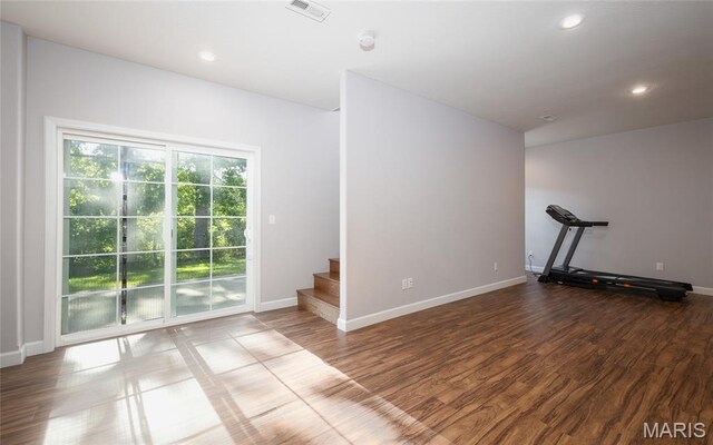 1347 Thomas Dr, Rolla, MO 65401 - unfurnished room featuring baseboards, stairs, recessed lighting, wood finished floors, and a smoke detector