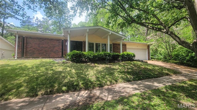 5489 Limerick Dr, Saint Louis, MO 63128 - ranch-style home with brick siding, a front yard, an attached garage, and driveway