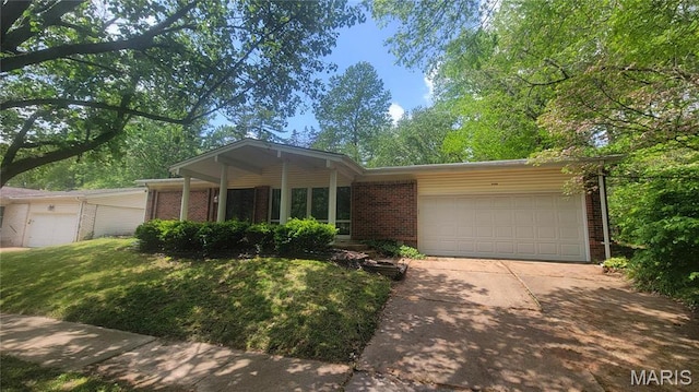 5489 Limerick Dr, Saint Louis, MO 63128 - view of front of property featuring brick siding, concrete driveway, a garage, and a front yard