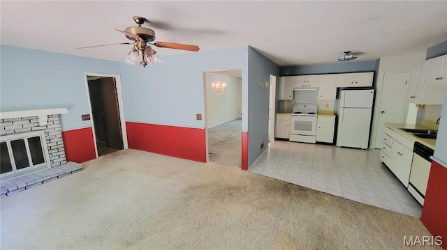 5489 Limerick Dr, Saint Louis, MO 63128 - unfurnished living room featuring light colored carpet, ceiling fan, a chandelier, a textured ceiling, and a brick fireplace