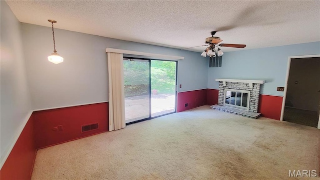 5489 Limerick Dr, Saint Louis, MO 63128 - unfurnished living room with ceiling fan, carpet flooring, a textured ceiling, and a brick fireplace