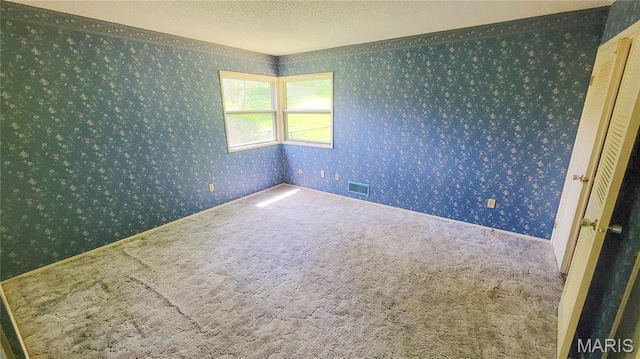 5489 Limerick Dr, Saint Louis, MO 63128 - carpeted spare room with wallpapered walls and a textured ceiling