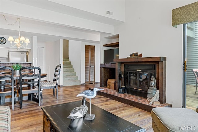 45 S Lionshead Dr, Innsbrook, MO 63390 - living room featuring wood finished floors, a chandelier, and stairs