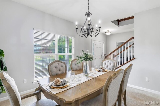 153 Stella Cherry Way, Wildwood, MO 63040 - dining area with baseboards, a chandelier, stairway, and light carpet