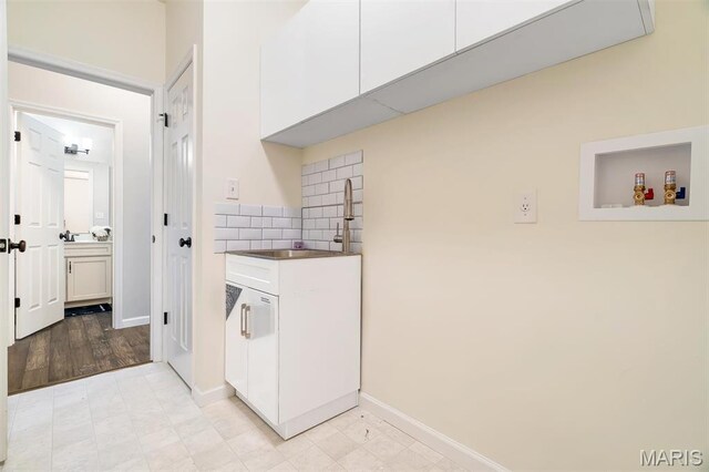 153 Stella Cherry Way, Wildwood, MO 63040 - washroom with cabinet space, baseboards, and washer hookup