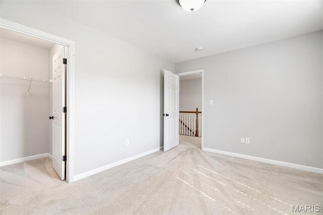 153 Stella Cherry Way, Wildwood, MO 63040 - unfurnished bedroom with carpet floors, a walk in closet, baseboards, and a closet