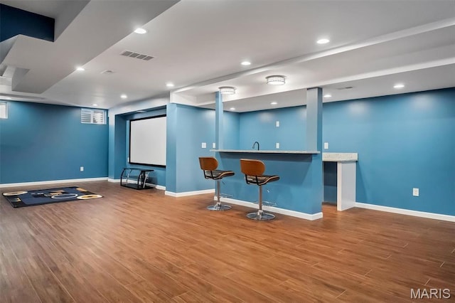153 Stella Cherry Way, Wildwood, MO 63040 - cinema room with bar with sink, wood finished floors, baseboards, and recessed lighting