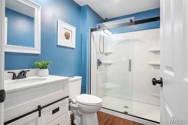 153 Stella Cherry Way, Wildwood, MO 63040 - bathroom featuring a shower stall, toilet, wood finished floors, and vanity