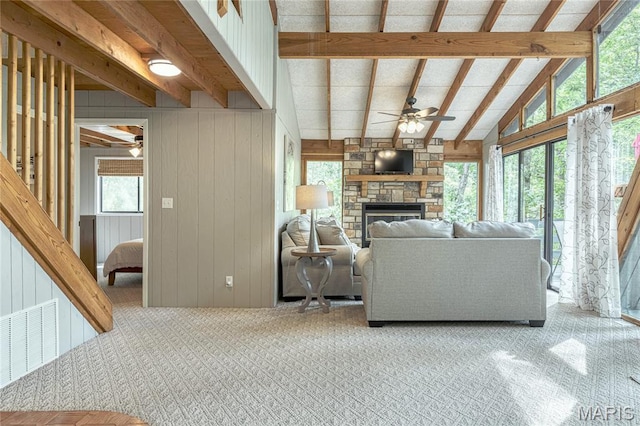 1235 Powderhorn Dr, Innsbrook, MO 63390 - carpeted living area with ceiling fan, a stone fireplace, and wood walls