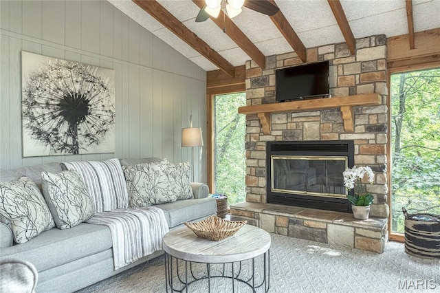 1235 Powderhorn Dr, Innsbrook, MO 63390 - living room with plenty of natural light, a stone fireplace, carpet flooring, ceiling fan, and wood walls