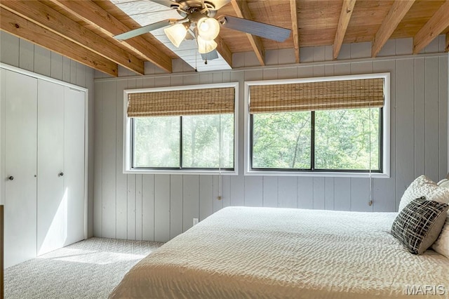 1235 Powderhorn Dr, Innsbrook, MO 63390 - bedroom with beamed ceiling, wood walls, carpet floors, a closet, and a ceiling fan