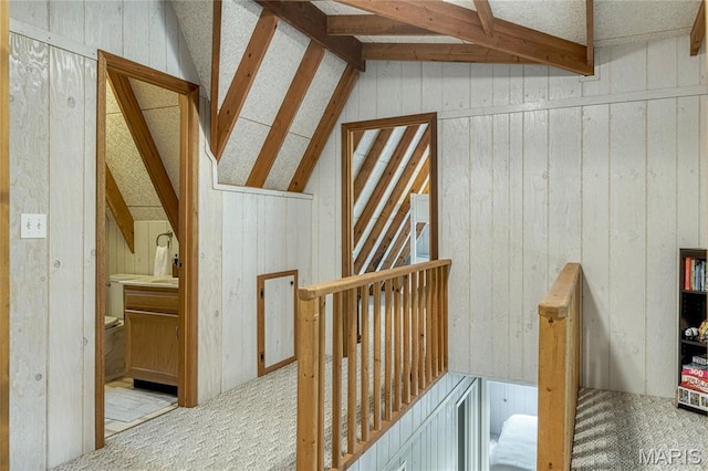 1235 Powderhorn Dr, Innsbrook, MO 63390 - hall featuring carpet floors, vaulted ceiling, and wood walls