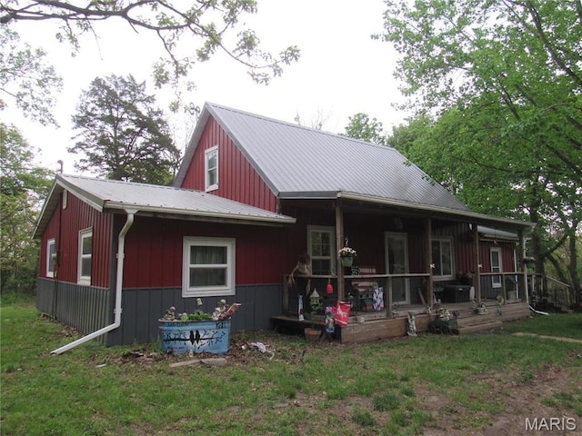 2375 Argo Rd, Cuba, MO 65453 - rear view of house with metal roof, a porch, and a yard