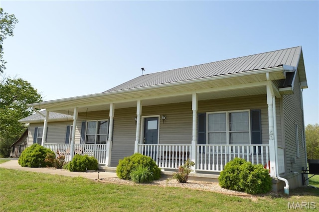 3 Green Valley Ln, Hermann, MO 65041 - view of front of home with covered porch, a front yard, and metal roof