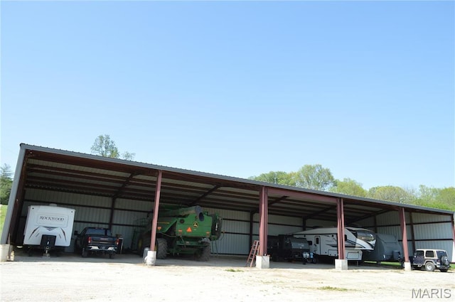 3 Green Valley Ln, Hermann, MO 65041 - view of car parking featuring a detached carport, dirt driveway, and a pole building