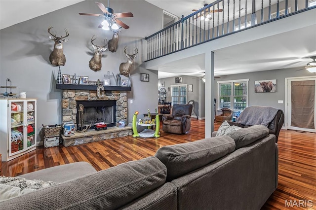 802 Hager Rd, Farmington, MO 63640 - living room with ceiling fan, a towering ceiling, a stone fireplace, and wood finished floors