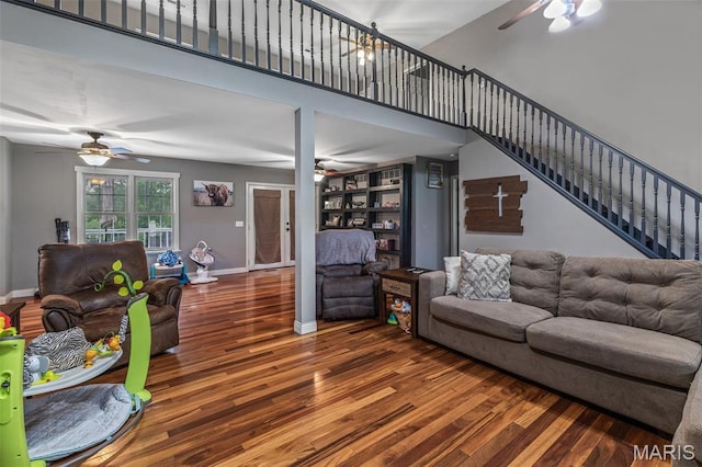 802 Hager Rd, Farmington, MO 63640 - living area featuring ceiling fan, wood finished floors, stairs, baseboards, and a high ceiling
