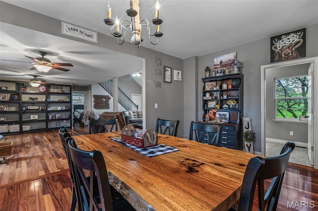 802 Hager Rd, Farmington, MO 63640 - dining space featuring stairway, dark wood-style floors, a chandelier, and baseboards