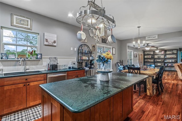 802 Hager Rd, Farmington, MO 63640 - kitchen featuring a sink, stainless steel dishwasher, dark wood-style floors, brown cabinets, and a center island