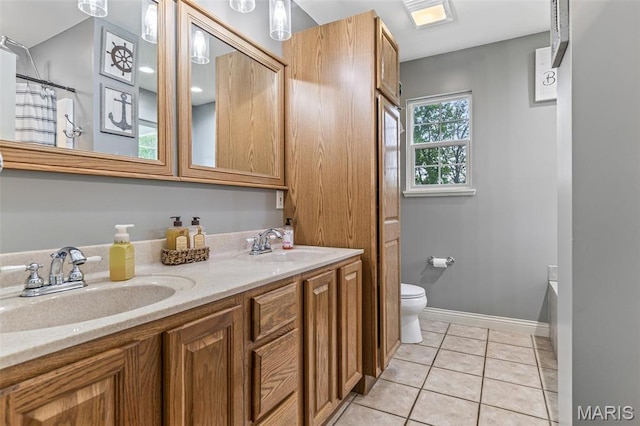 802 Hager Rd, Farmington, MO 63640 - full bathroom featuring double vanity, toilet, tile patterned flooring, and baseboards