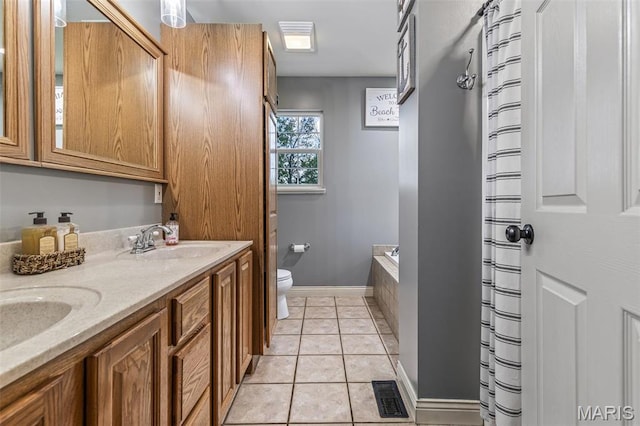 802 Hager Rd, Farmington, MO 63640 - bathroom with toilet, double vanity, tile patterned floors, a tub to relax in, and baseboards