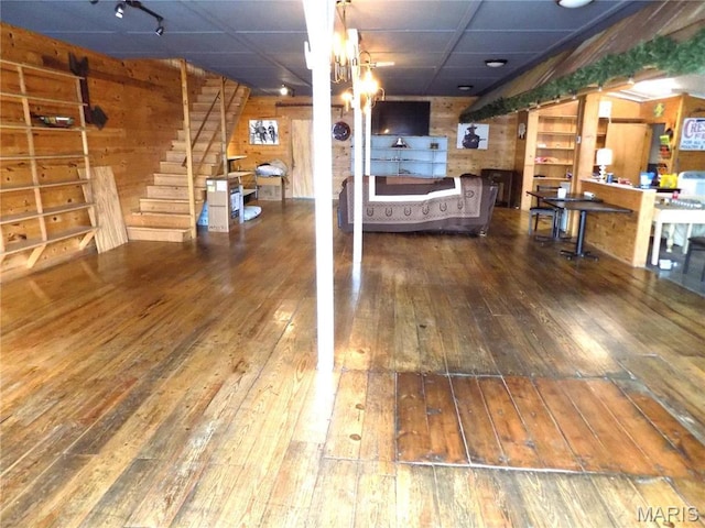 491 Broadway St, Edgar Springs, MO 65462 - living area featuring wood-type flooring, a drop ceiling, stairway, and wood walls