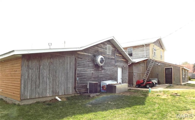 491 Broadway St, Edgar Springs, MO 65462 - back of property with cooling unit, an outdoor structure, and a lawn