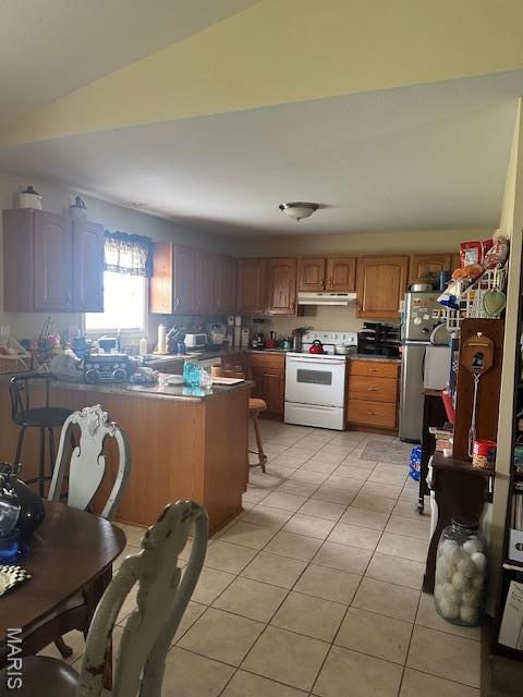806 Susan St A-B, Unit A-B Dexter, MO 63841 - kitchen with white electric stove, under cabinet range hood, freestanding refrigerator, brown cabinets, and light tile patterned floors