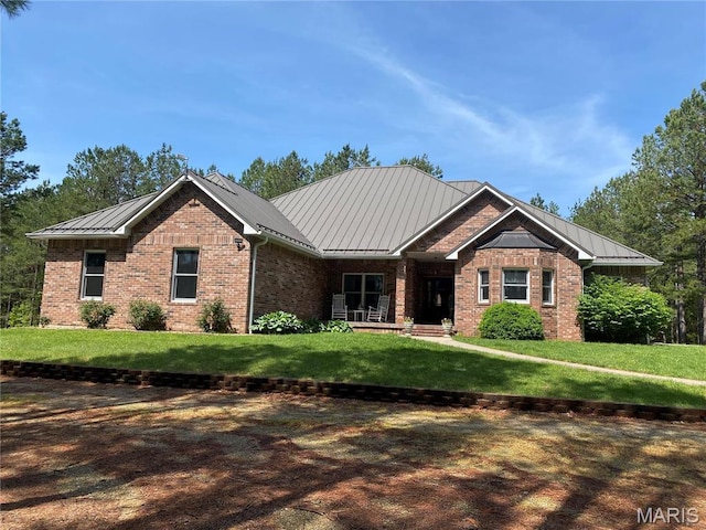 14035 County Road 4110, Rolla, MO 65401 - view of front of house featuring a standing seam roof, brick siding, and a front yard