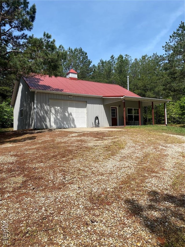 14035 County Road 4110, Rolla, MO 65401 - exterior space with metal roof, dirt driveway, and a garage