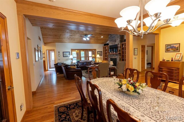 14035 County Road 4110, Rolla, MO 65401 - dining room featuring vaulted ceiling, a ceiling fan, light wood-style flooring, a chandelier, and a stone fireplace