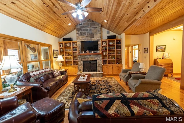 14035 County Road 4110, Rolla, MO 65401 - living room with wood finished floors, lofted ceiling, ceiling fan, wood ceiling, and a stone fireplace