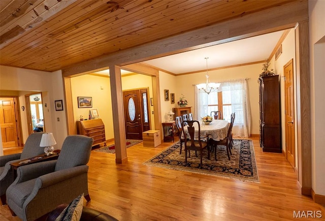 14035 County Road 4110, Rolla, MO 65401 - dining space with a chandelier, light wood finished floors, crown molding, and baseboards