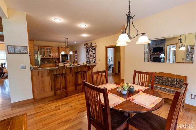 14035 County Road 4110, Rolla, MO 65401 - dining area with light wood finished floors, a chandelier, recessed lighting, and baseboards