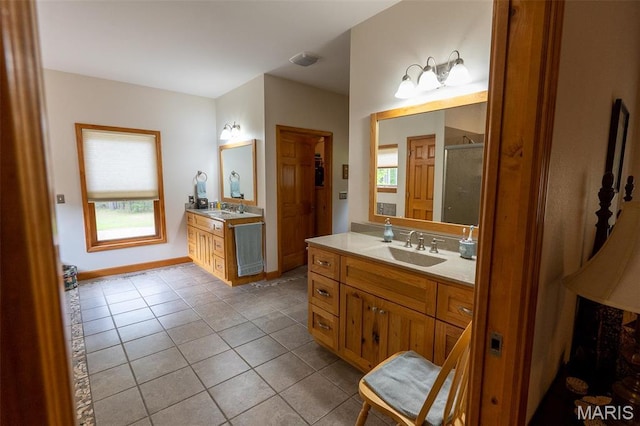 14035 County Road 4110, Rolla, MO 65401 - bathroom with tile patterned floors, a stall shower, healthy amount of natural light, and two vanities