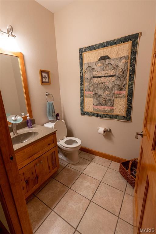14035 County Road 4110, Rolla, MO 65401 - bathroom with tile patterned floors, toilet, and vanity