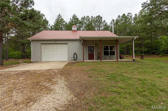 14035 County Road 4110, Rolla, MO 65401 - view of front of property featuring concrete driveway, an attached garage, a front yard, a porch, and a chimney