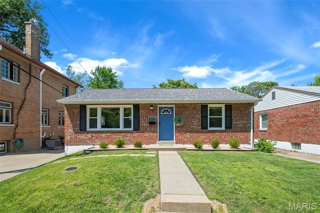 6939 Dartmouth Ave, University City, MO 63130 - view of front of home featuring central AC unit, brick siding, a front yard, and roof with shingles