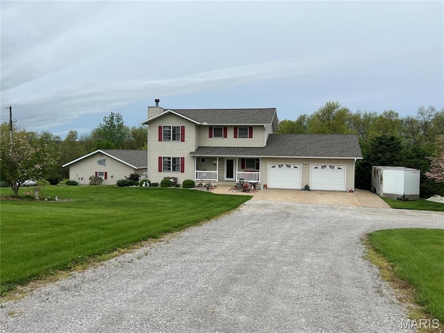 7070 Goldenrod Rd, Hannibal, MO 63401 - view of front of property featuring a porch, an attached garage, driveway, a front lawn, and a chimney
